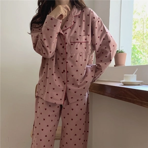 Pink women's pajamas set with red heart patterns and long sleeves in soft brushed fabric