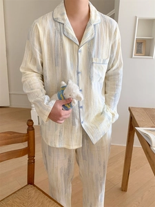 Detail view of cotton couple pajamas showing artistic brush stripes and textured fabric