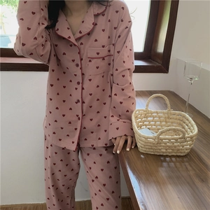 Detail showing pink pajama set with red heart pattern and soft brushed cotton texture