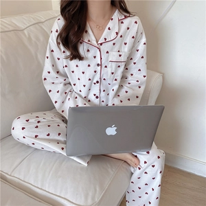 Detail of sweet heart print pajama set featuring soft fabric and red piping on pockets