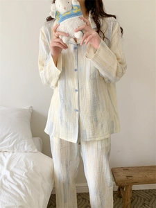 Detail of cotton pajama set with abstract stripes and blue piping for lounge comfort