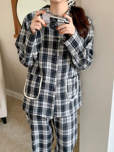 Detail of black and white checkered pajama set with pockets and button-down front