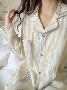 Detail of soft striped cotton pajama top with classic lapel and purple piping detail
