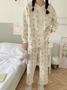 Detailed close-up of floral winter pajama set featuring heart-shaped buttons and pockets