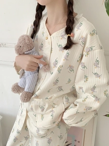 Detail of floral air cotton pajamas featuring lace collar and delicate ribbon bows