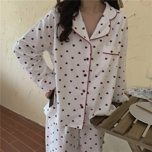 Detail of soft brushed pajamas with red heart prints and classic button-down collar