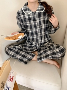Detail of checkered pajamas featuring Peter Pan collar and soft black and white fabric