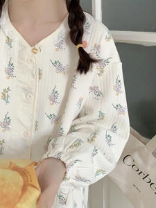 Detail of floral air cotton pajama top featuring lace doll collar and button closure