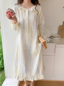 Detail of ruffle doll collar and button placket on light yellow striped cotton sleepwear