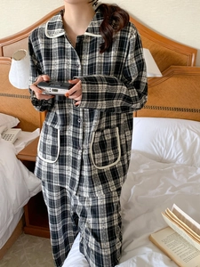 Detail of checkered pajama set with white piped edges and soft cotton texture