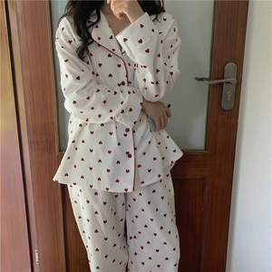 Detail of sweet heart print pajama set featuring lapel collar and red piping edges