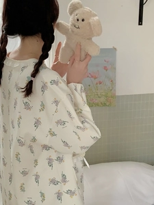 Detail of floral lounge wear with white lace collar and elastic cuffs in soft cotton
