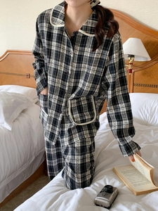 Detail of classic black and white plaid pajama set with soft cotton fabric texture