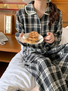 Close-up of black and white checkered pajama set with contrast piping and button details