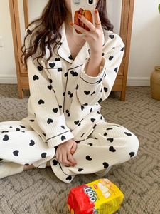 Detailed texture of thick cream pajamas with black heart prints and ribbed fabric