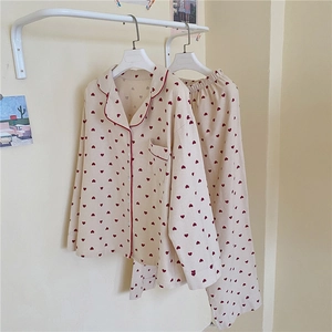 Close-up of sweet heart print pajamas featuring red piping and delicate button details
