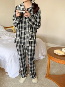Detail of classic black and white plaid pajama set with lapel collar and soft texture