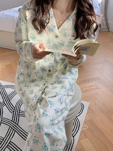 Close-up of floral cotton pajamas featuring green round buttons and a soft notched lapel