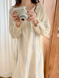 Detail of ruffle collar and vertical stroke patterns on soft cotton pajama dress