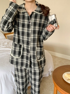 Close-up of black and white plaid pajama set with button-down shirt and soft cotton fabric