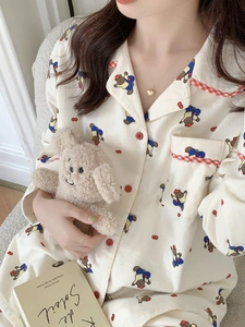 Détail d'un pyjama en coton doux avec motifs d'ours mignons et boutons rouges