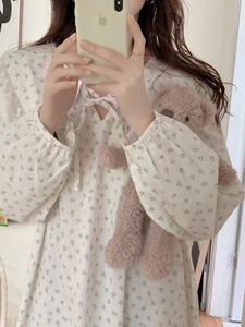 Detail of elegant floral cotton nightdress with lace collar and lantern sleeves decoration