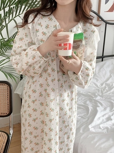 Detail of floral cotton nightgown featuring white lace collar and elastic cuffs