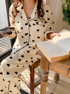 Detailed view of women's warm heart print pajama set with contrast piping and pocket