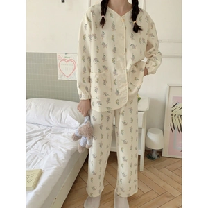 Women's cream cotton floral pajamas set with long sleeves and pocket in cozy bedroom