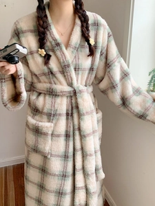 Detail of plush checkered flannel robe with waist tie and large functional pockets