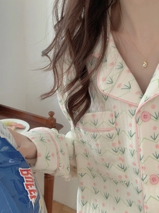 Detail of floral quilted pajamas featuring pink piping, buttons, and a front pocket