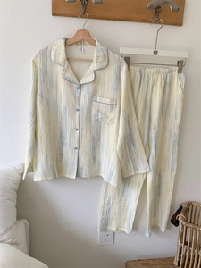 Detail of floral print cotton pajamas showing blue piping, collar and breast pocket
