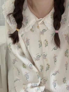 Close-up of floral cotton pajama set featuring Peter Pan collar and delicate lace trim