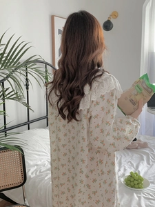 Detailed back view of a long-sleeve cotton nightgown with floral print and lace collar