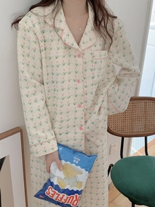 Close-up of lapel collar with pink trim and floral print on warm quilted pajamas