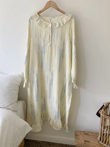 Detail of ruffled Peter Pan collar and textured cotton fabric on long-sleeve nightgown