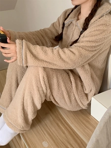 Detail showing plush winter pajamas with elegant light blue piping on cuffs and collar