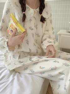 Detail of floral pajama set featuring a delicate lace Peter Pan collar and quilted texture