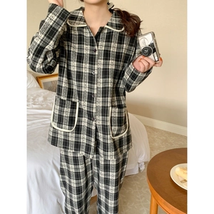 Women's minimalist black and white checkered long-sleeved pajamas set in cozy home setting