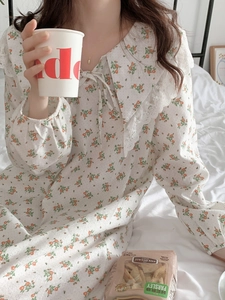 Close-up of floral cotton nightgown featuring a lace collar and bow tie detail
