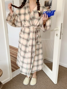 Detail view of plaid flannel robe showing the waist belt and soft coral fleece texture
