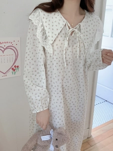 Close-up of elegant floral cotton nightdress featuring lace collar and bow detail