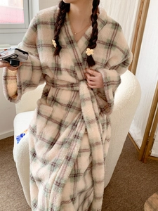 Detail view of plush checkered flannel bathrobe with soft texture and belted waist design