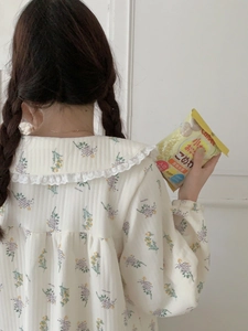 Detailed back view of cream floral pajamas featuring delicate lace collars and soft cotton texture