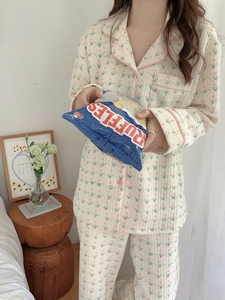 Detailed close-up of quilted floral pajamas showing the soft texture and pink button trim