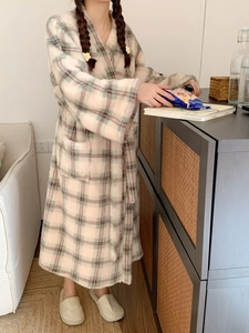 Detailed texture of thick plaid coral fleece bathrobe with waist belt and side pockets
