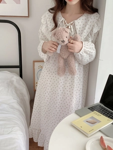 Detail showing the floral cotton nightgown with a lace collar and delicate bow tie