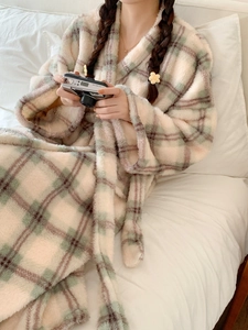 Detail of soft plaid flannel bathrobe with warm beige and purple grid textures