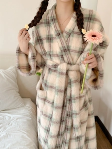 Detail of soft flannel texture on checkered bathrobe with plush fabric and pockets