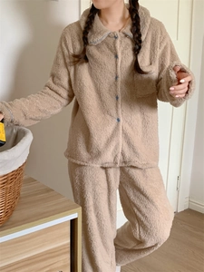 Detail of warm double-sided plush pajama set with blue piping and front chest pocket